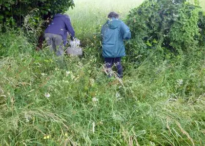 Photo d'une croix de Crozant en train d'être entretenue par des membres de l'association ASCTC pendant une action de débroussaillage.