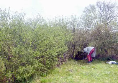 Photo d'une croix de Crozant en train d'être entretenue par des membres de l'association ASCTC pendant une action de débroussaillage.